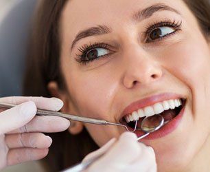 Learn More About General Dentistry women under dental examination