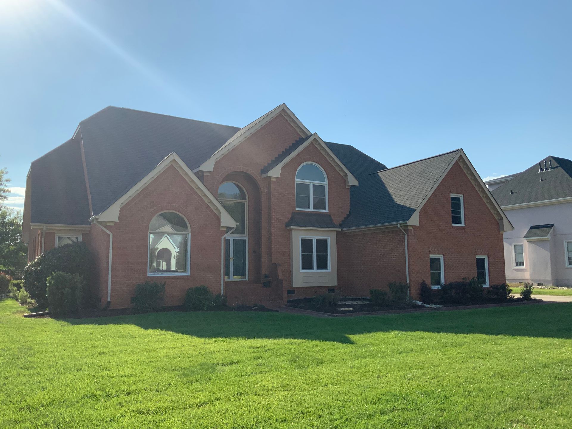 Brick house with new windows installed by Williamsburg Window
