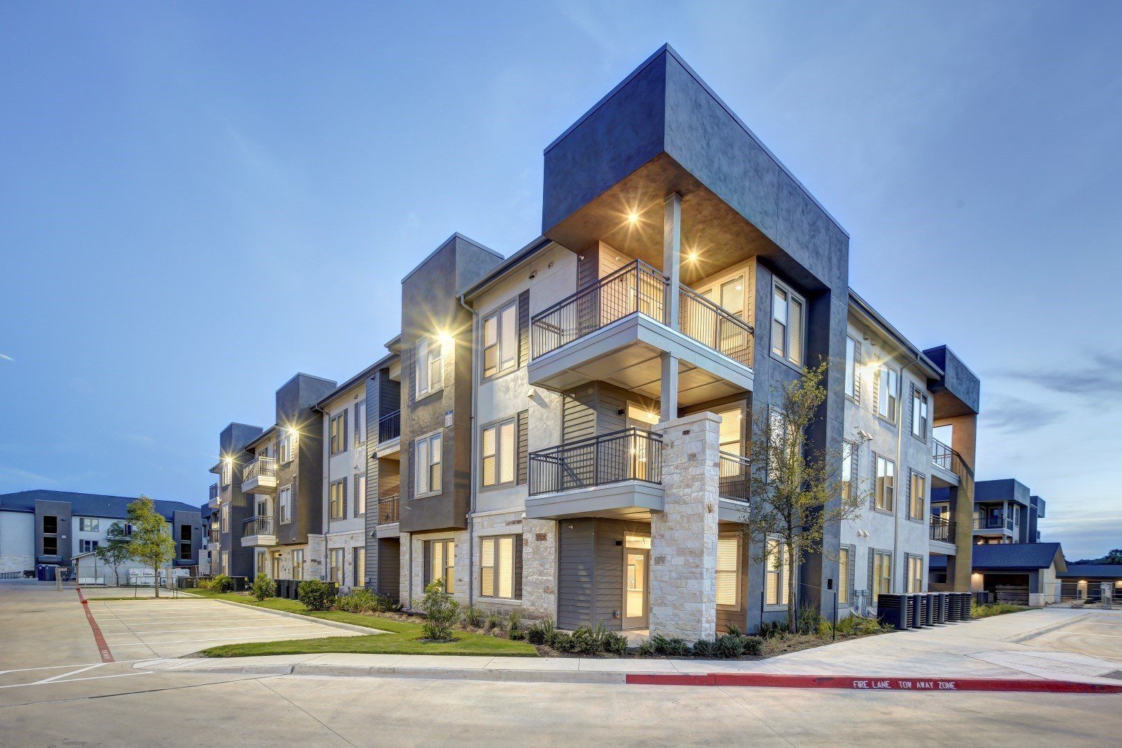 A large apartment building with a lot of windows and balconies.
