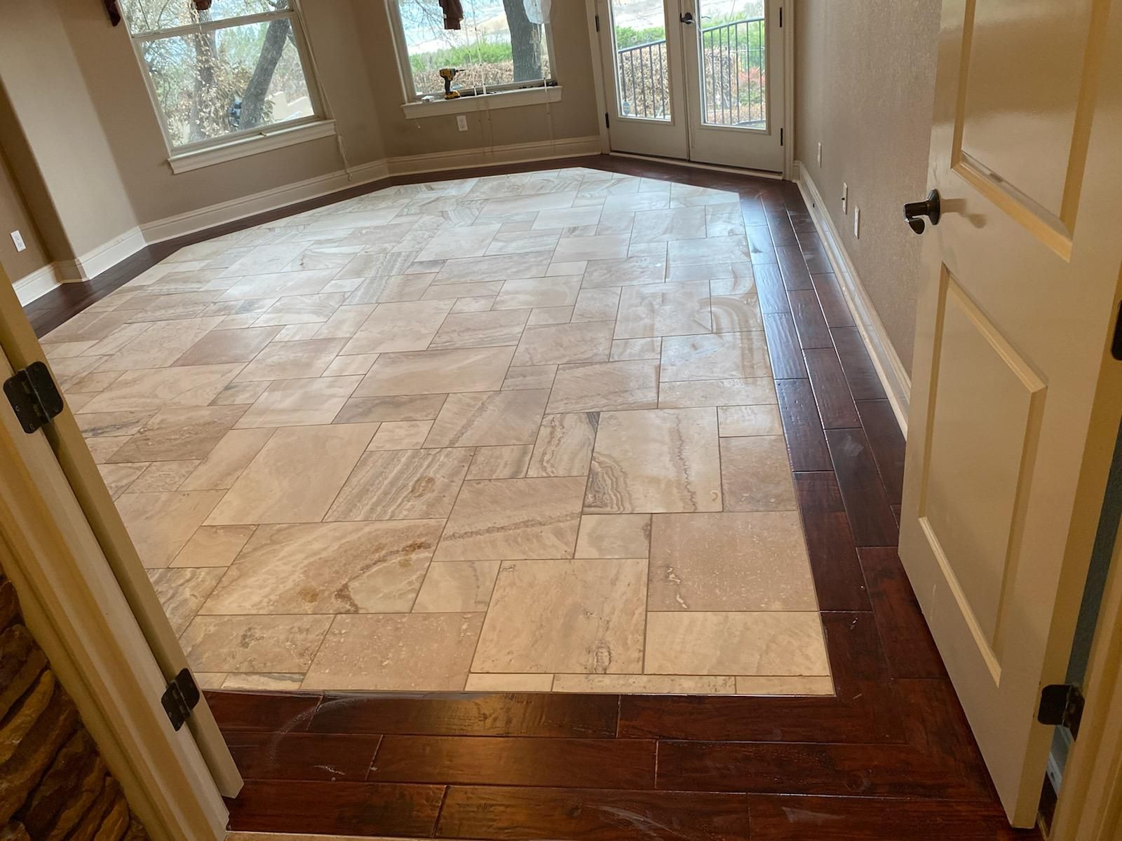 A room with a tiled floor and a wooden floor