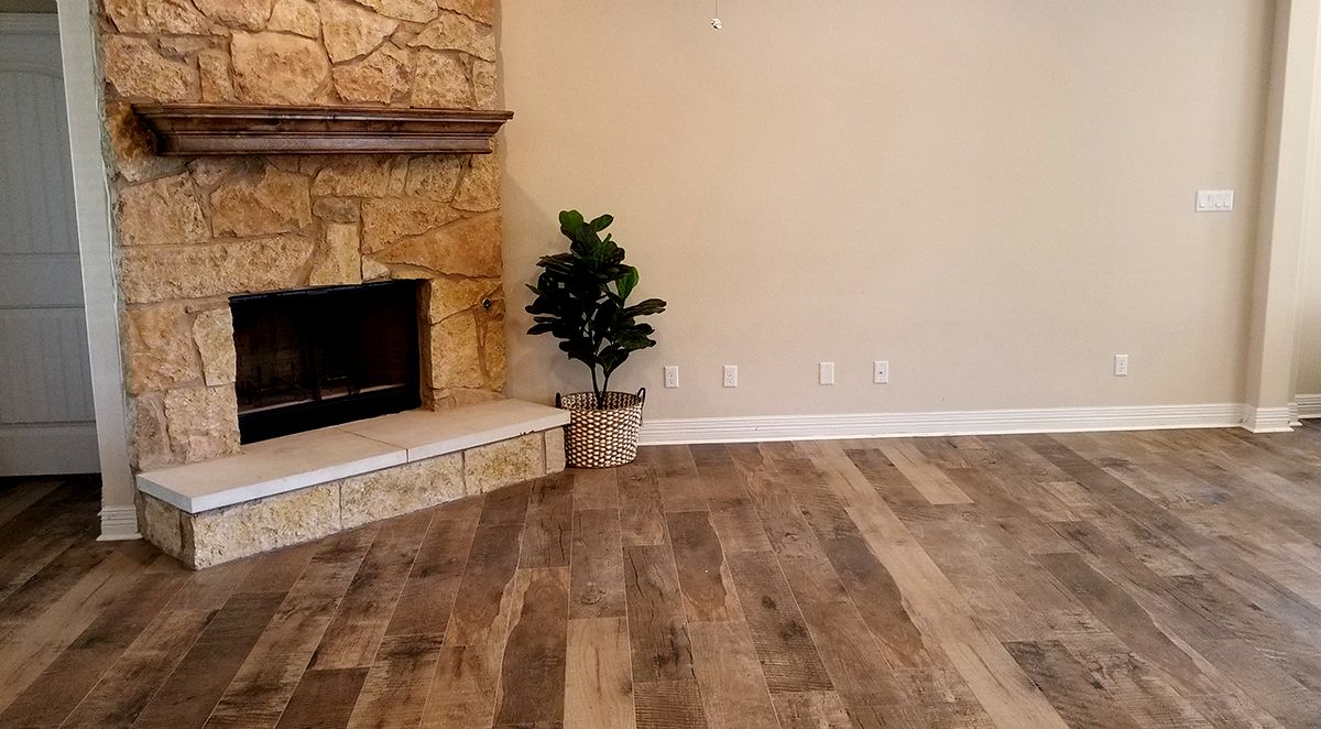 A living room with hardwood floors and a fireplace.