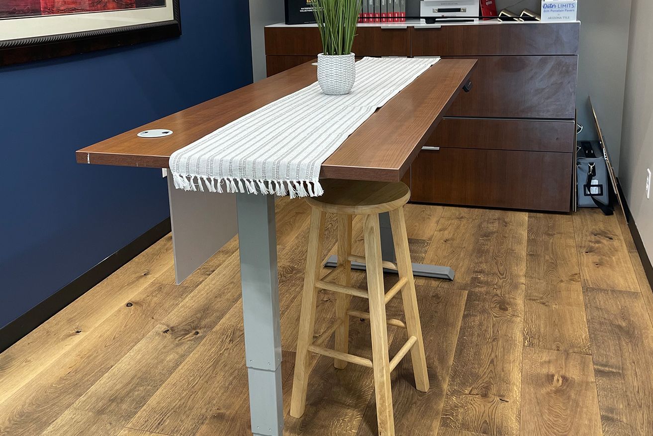 A wooden table with a plant on top of it in a room.