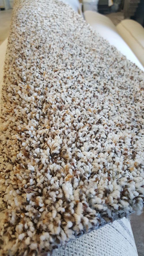 A close up of a piece of carpet on a couch.