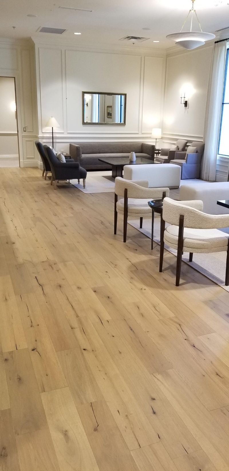 A living room filled with furniture and a wooden floor.