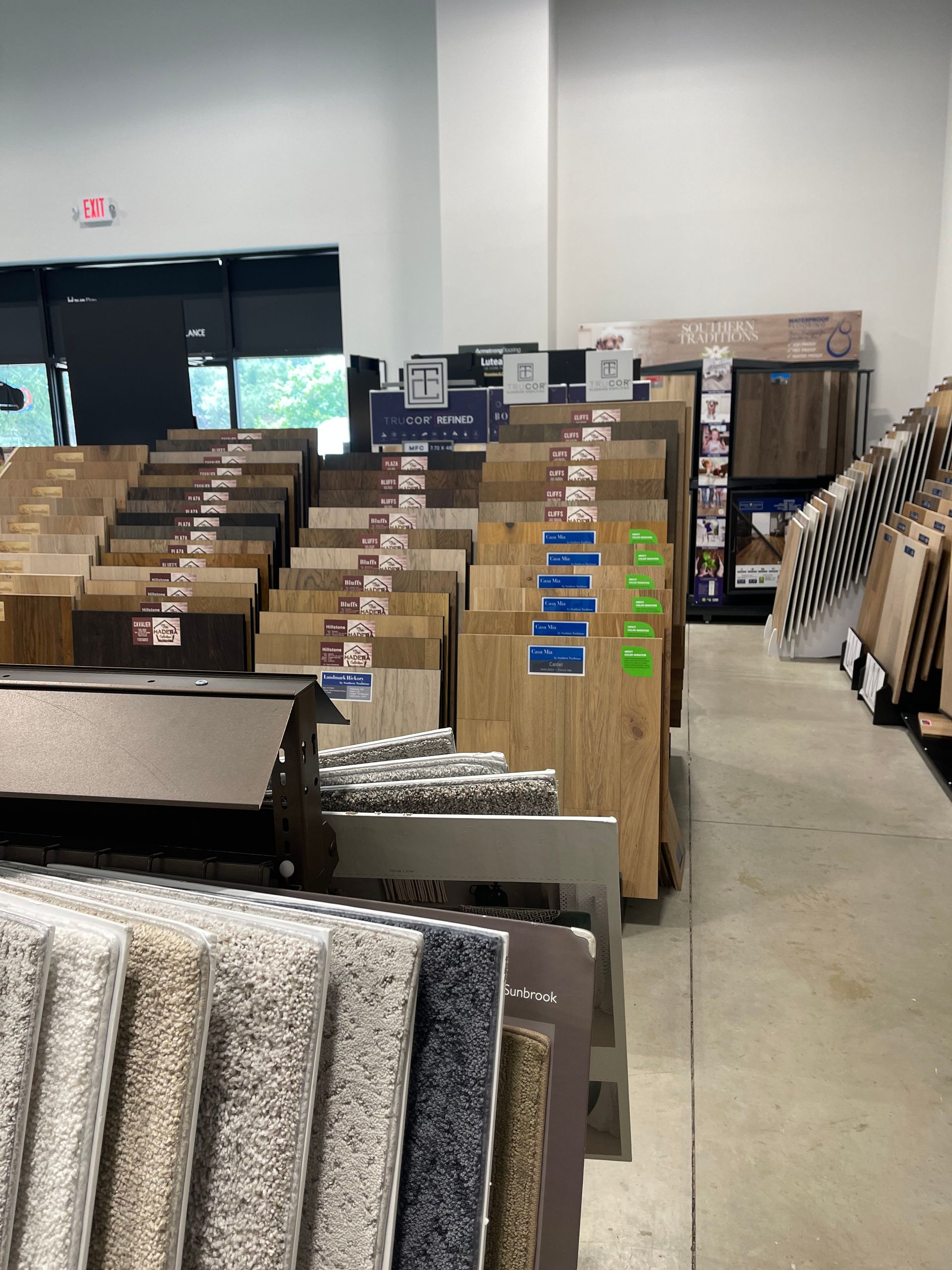 A warehouse filled with lots of carpets and wooden flooring
