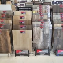 A display of different types of hardwood flooring in a store.