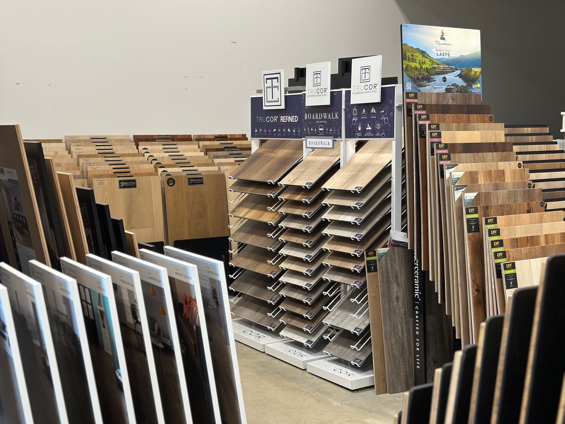 Displays of various wood and tile flooring samples in a showroom.