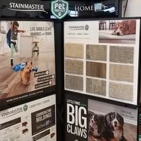 A display of carpets and tiles with a dog on it.