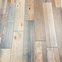 A close up of a wooden floor with a ruler on it.