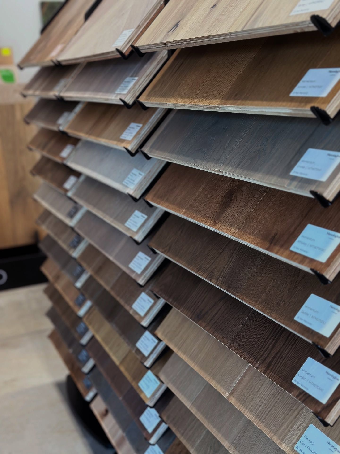 Display of various wood flooring samples in different shades.