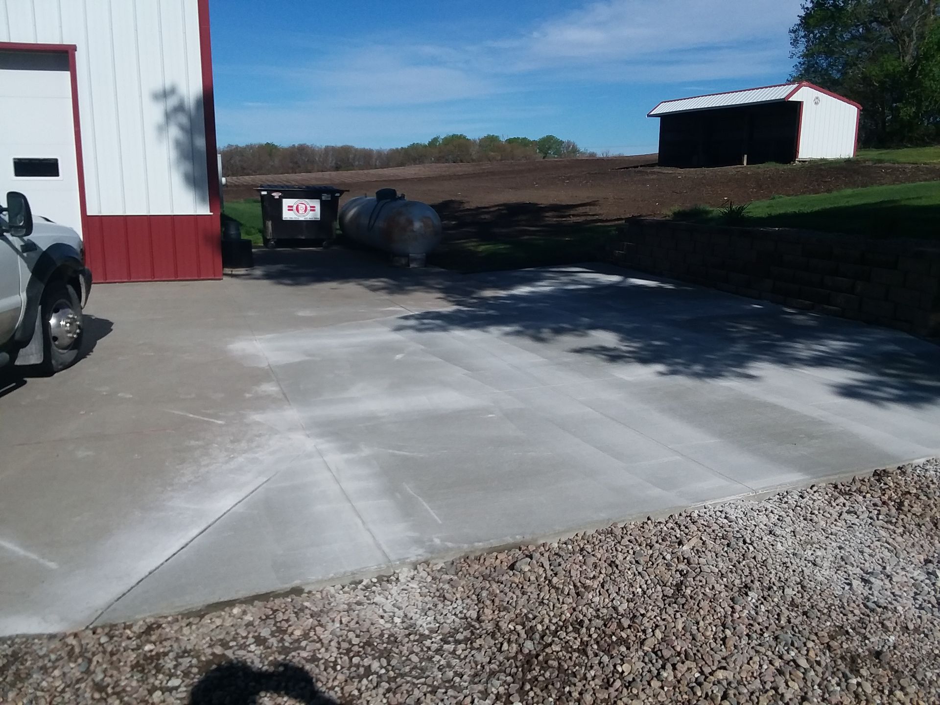 A truck is parked in a driveway next to a building