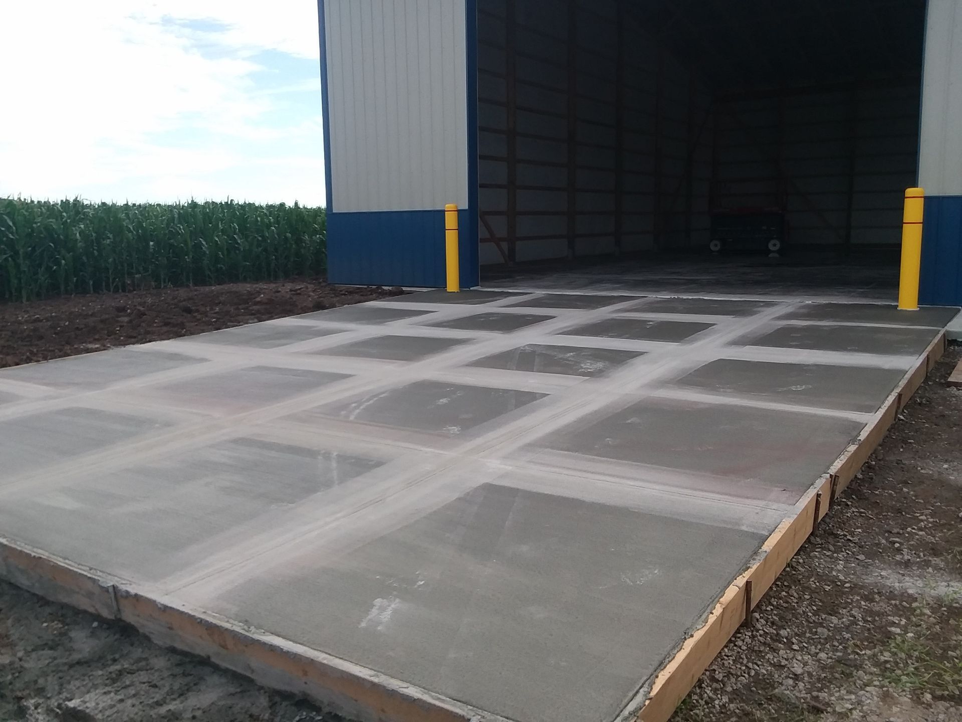 A concrete driveway is being built in front of a building