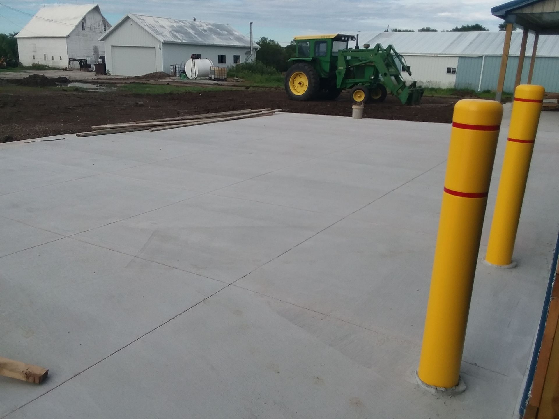 A john deere tractor is parked in a parking lot