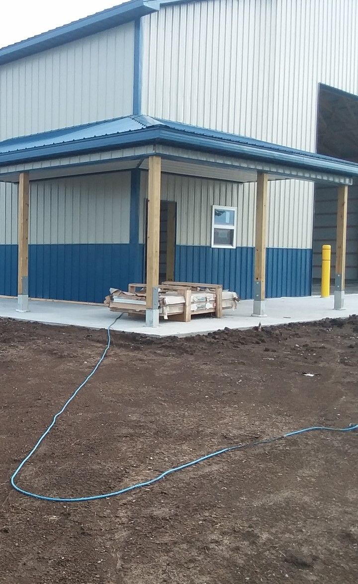 A building with a porch and a hose in front of it