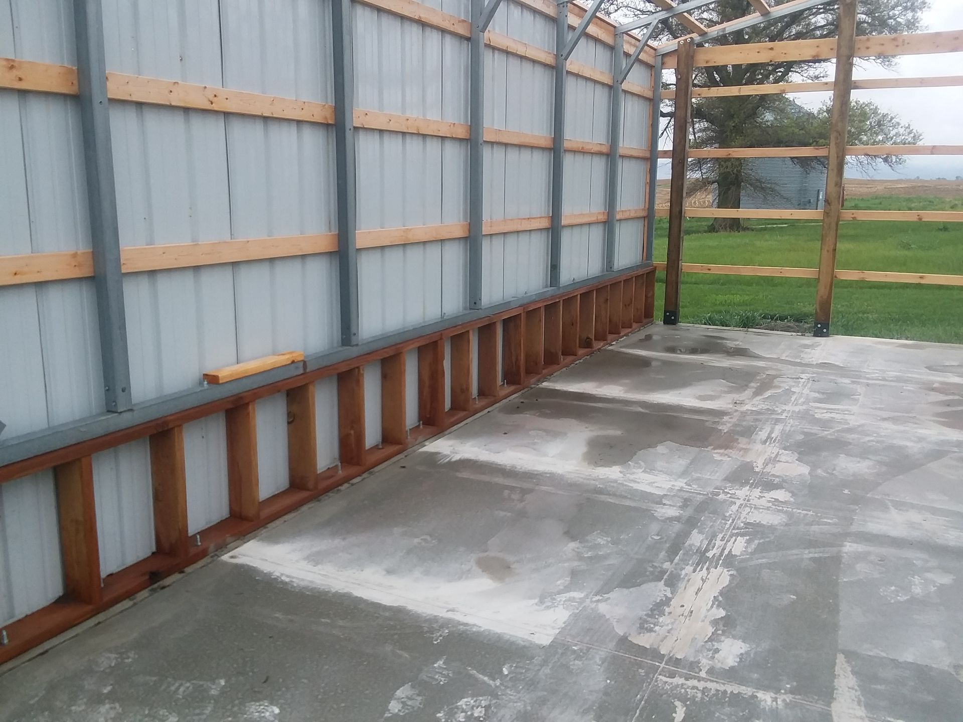 A wooden ladder is leaning against a metal wall