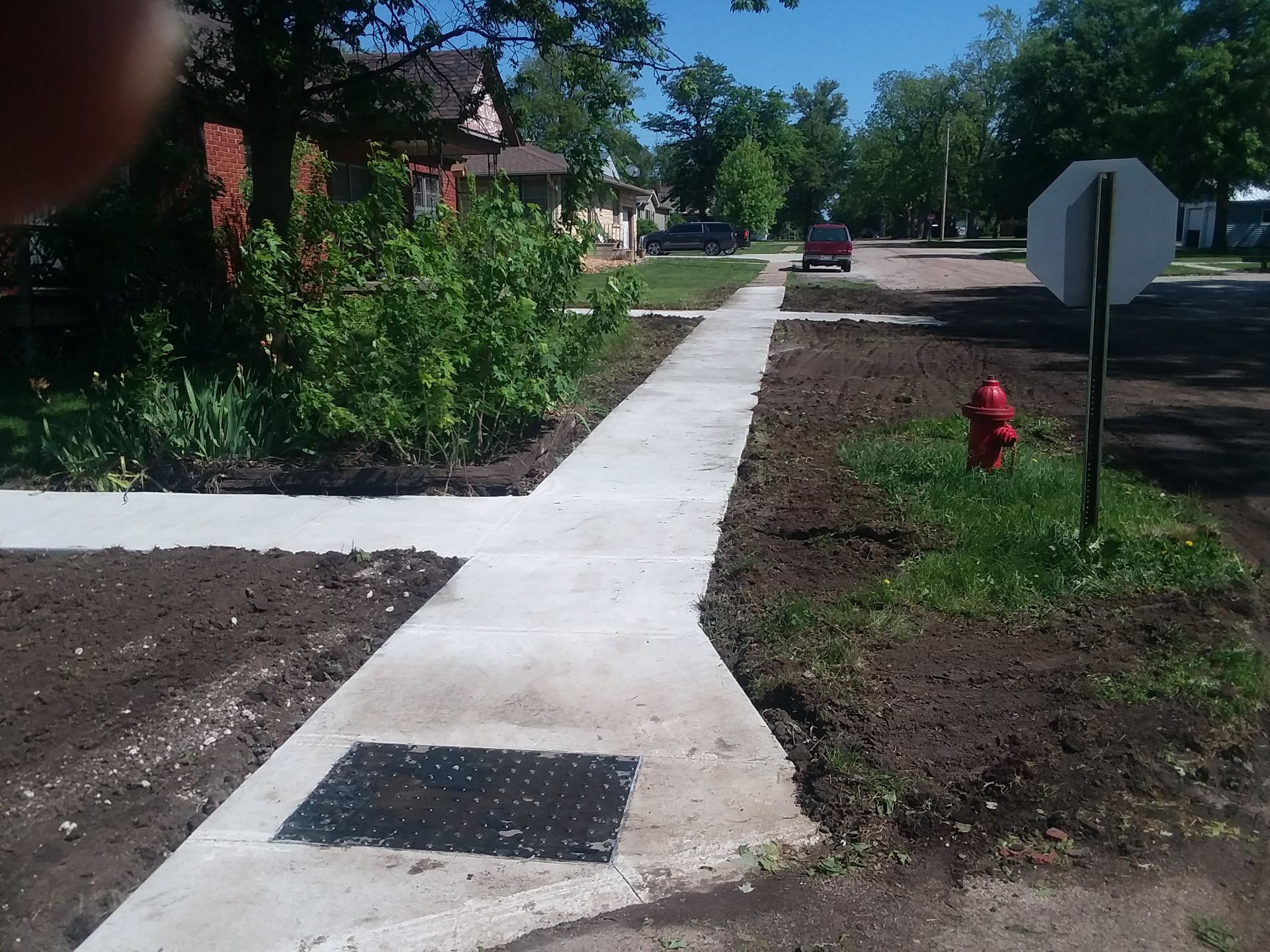 A sidewalk with a fire hydrant on the side of it