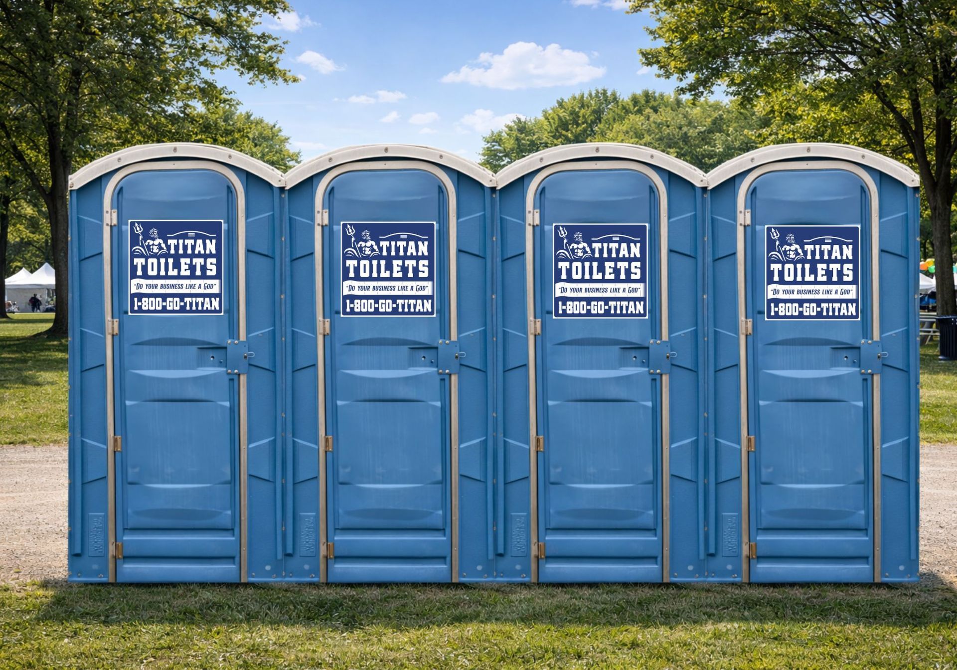 Four blue portable toilets lined up on grass under a partly cloudy sky