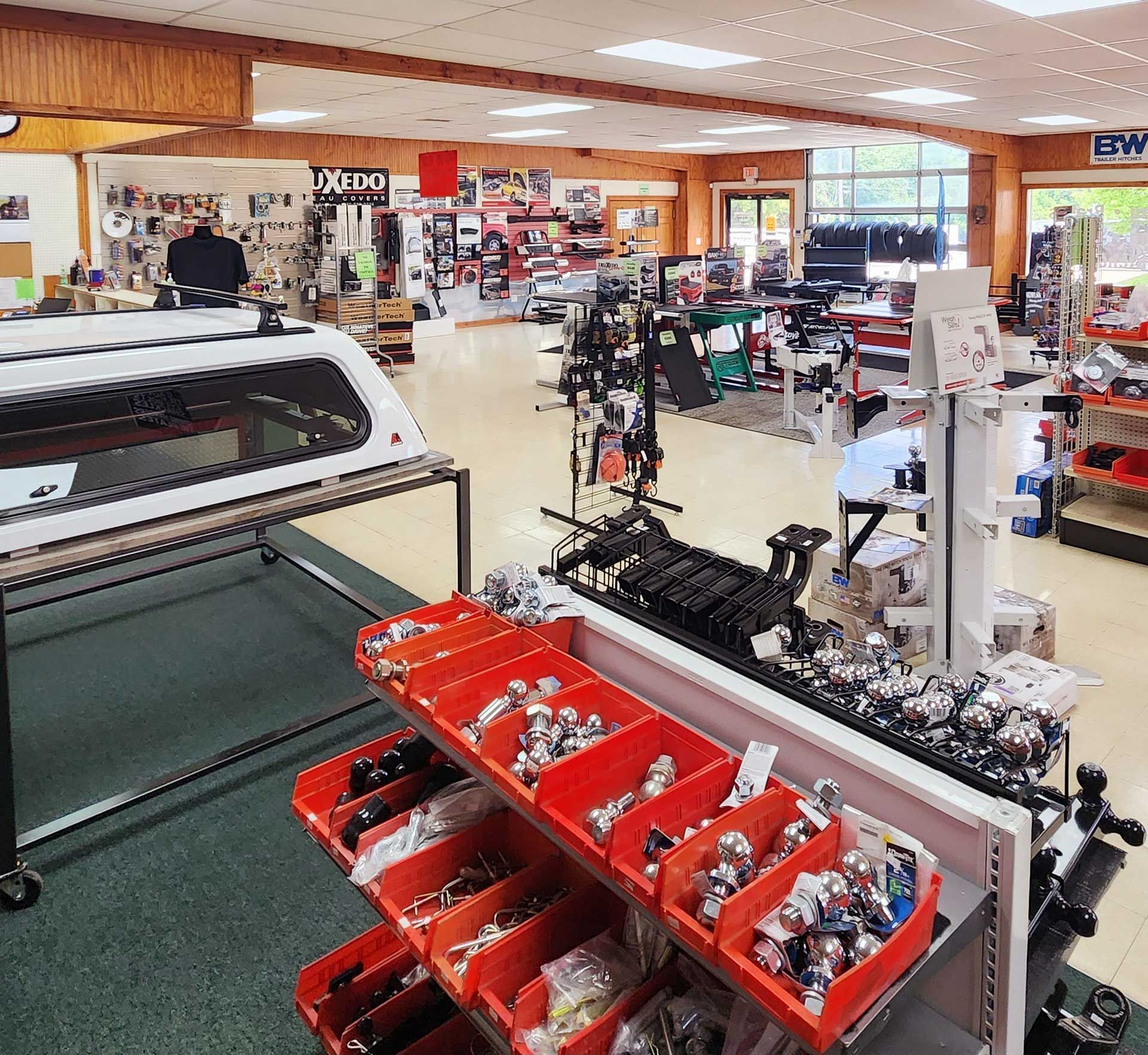 Toy store interior with shelves of model cars, red bins, and various toys under bright lighting