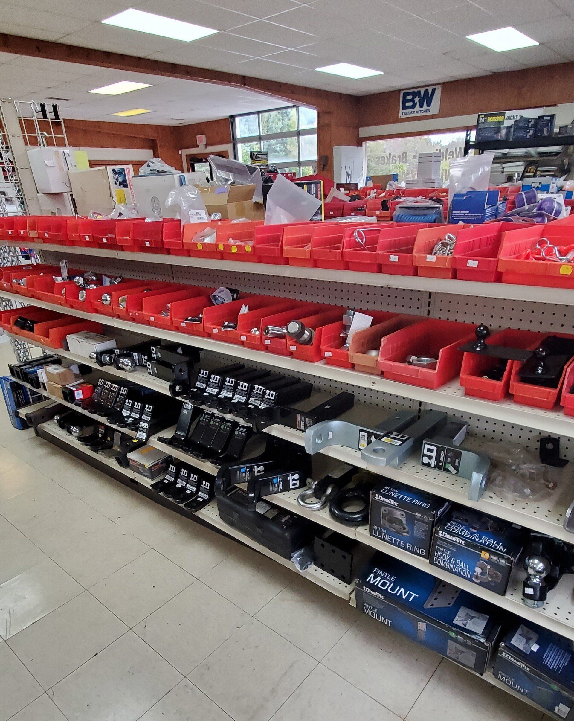 Shelves stocked with red and black boxed tools in a store aisle