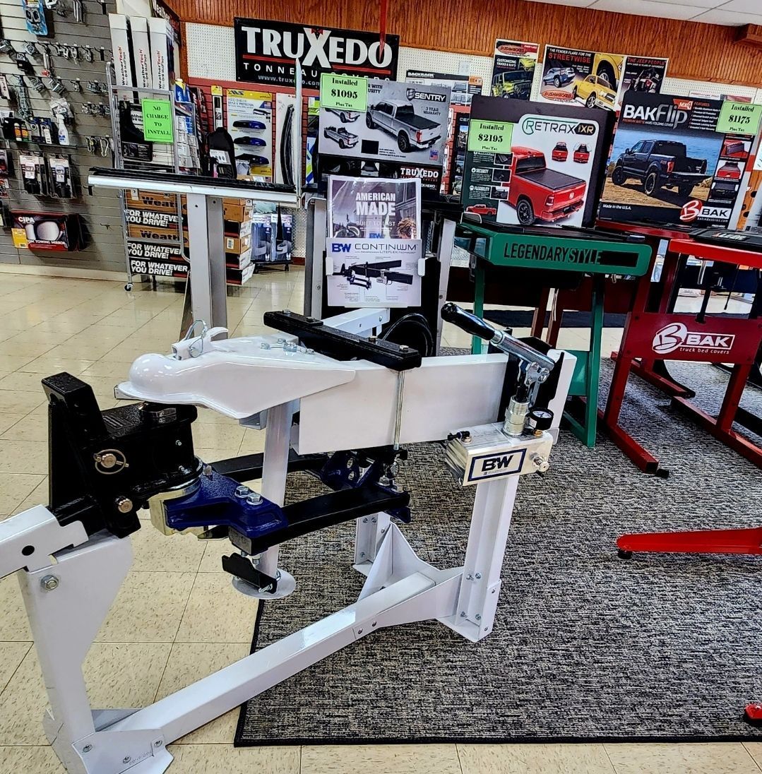White mechanical device in a showroom with TRXEDO signs and exercise equipment in the background