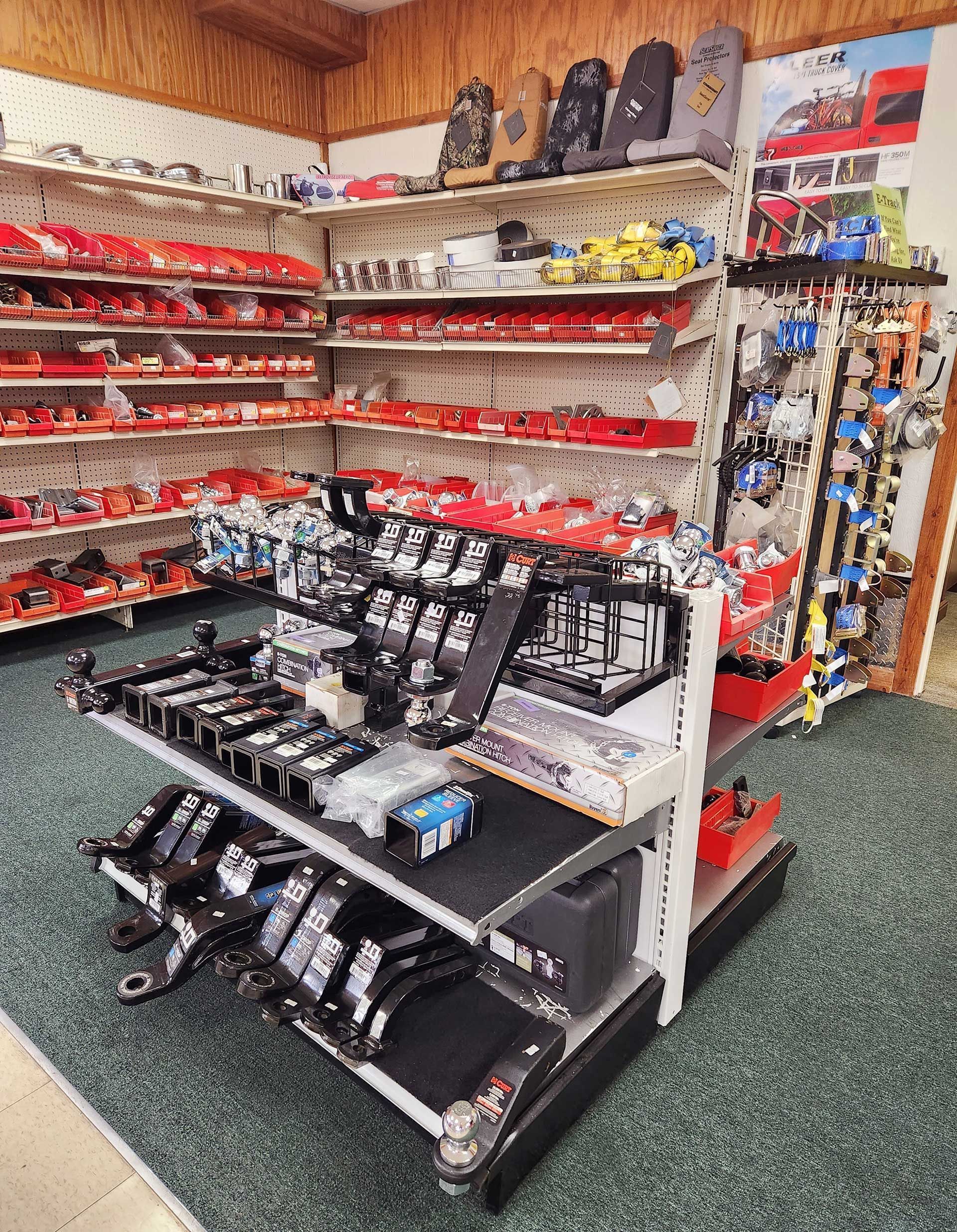 Small retail display of black and red accessories on shelves in a store aisle