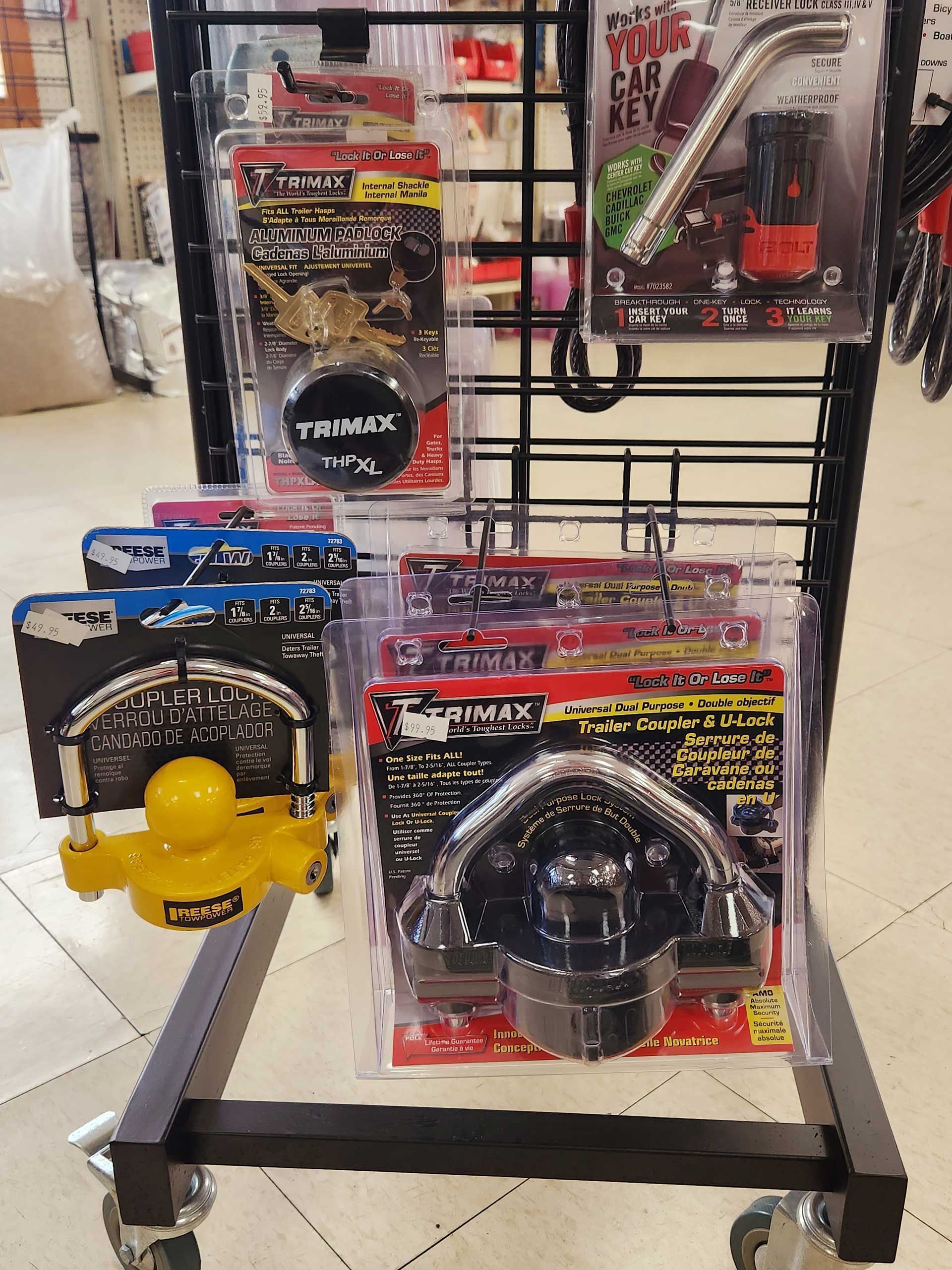 Bike locks displayed in retail packaging on a store shelf, including yellow and black models