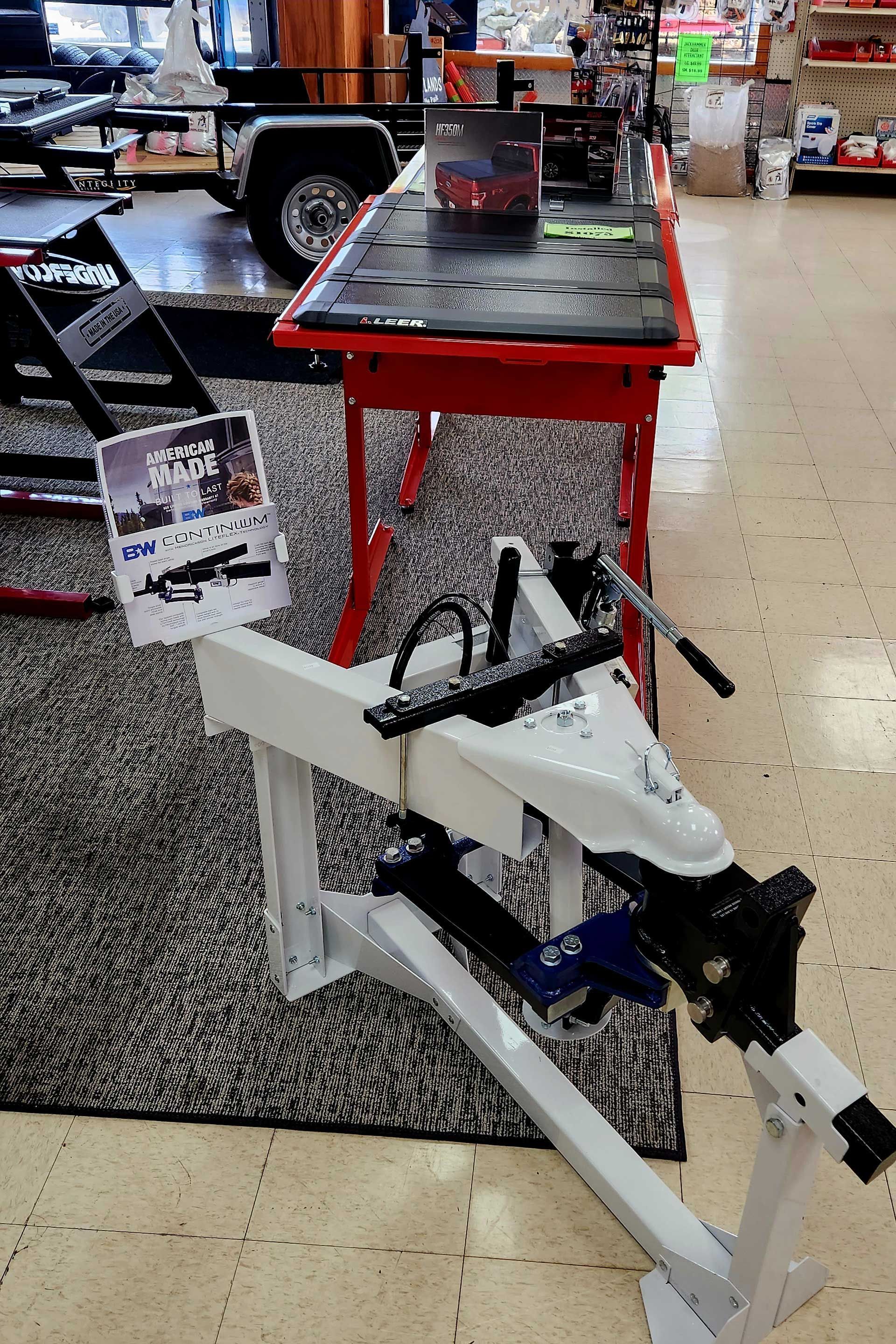 Red and white display rack with a white model boat in a store aisle