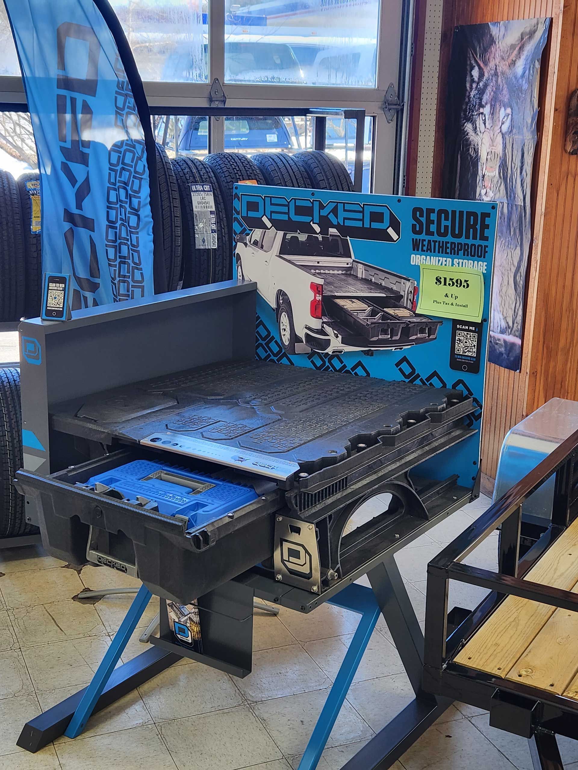 Black security checkpoint display with blue fencing and a bench in an indoor store.