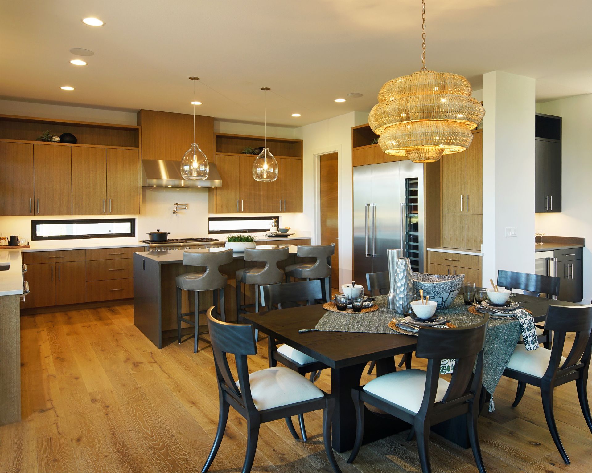 A kitchen and dining room with a table and chairs