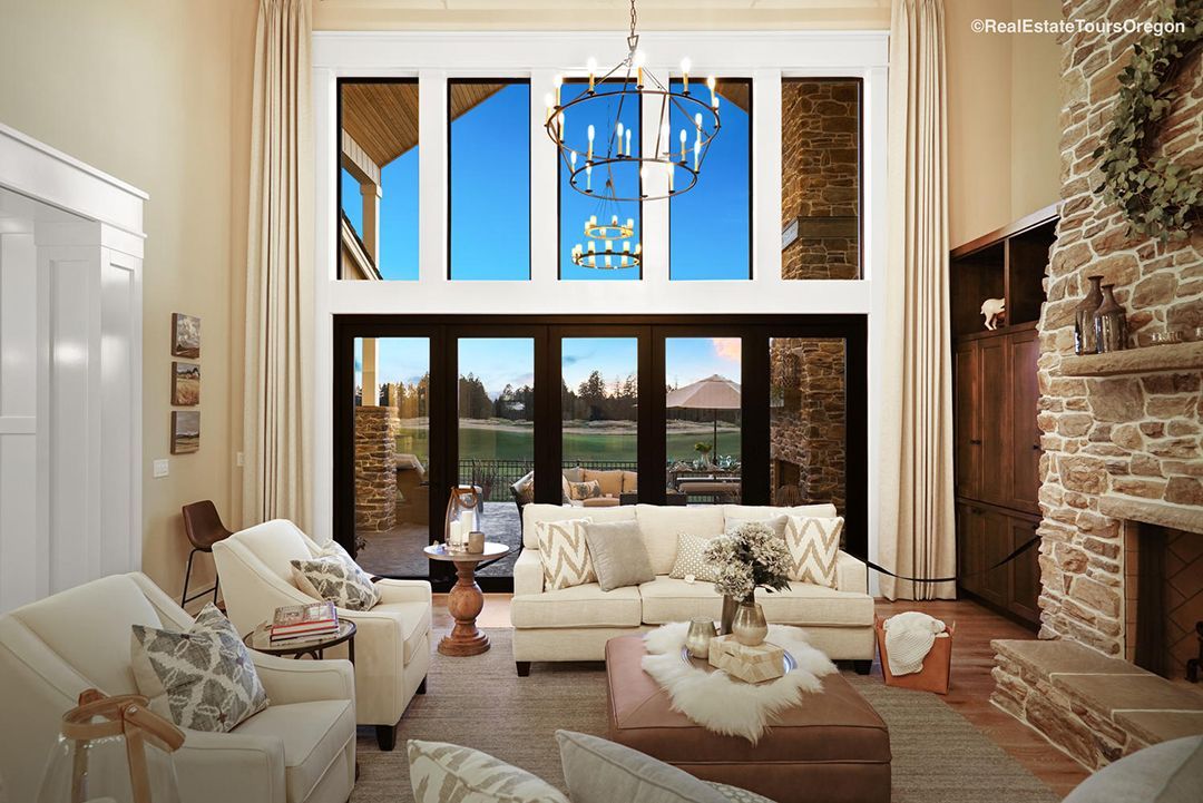 A living room with a couch , chairs , and a fireplace.