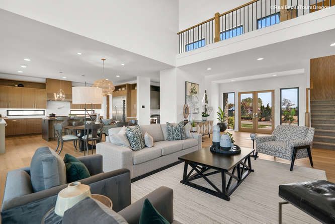 A living room with a couch , chairs , and a coffee table.