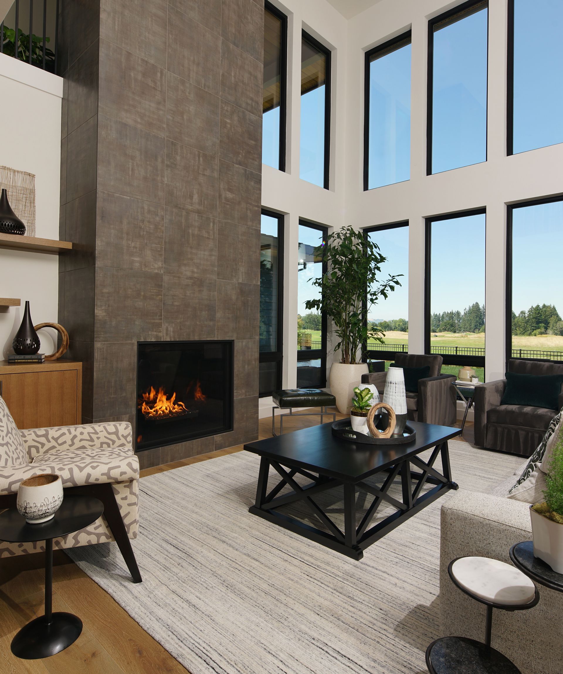 A living room with a fireplace and lots of windows