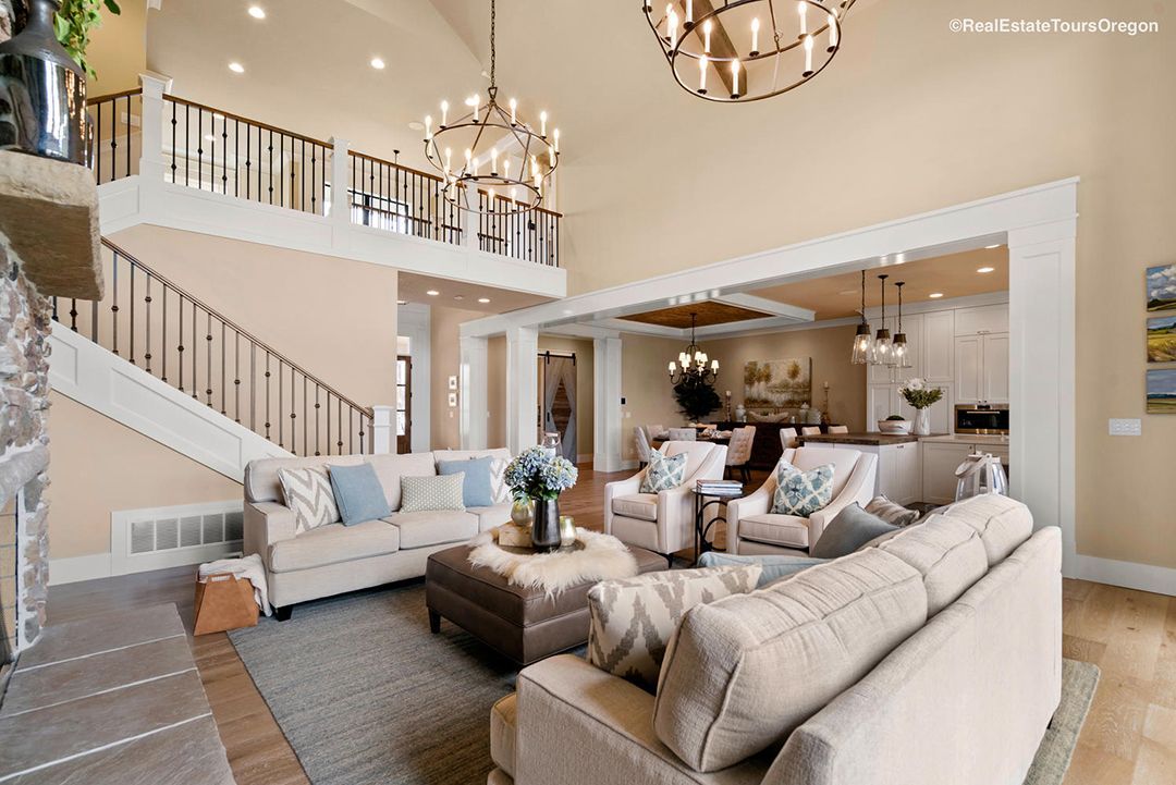A living room with a lot of furniture and a staircase