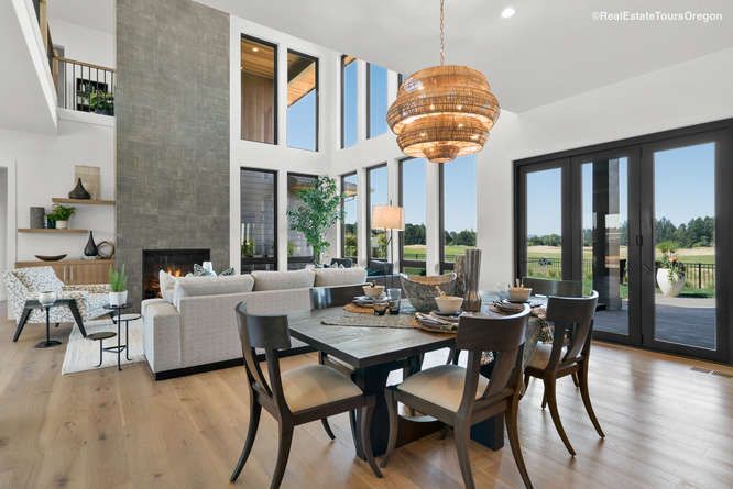 A living room with a dining table and chairs and a fireplace.
