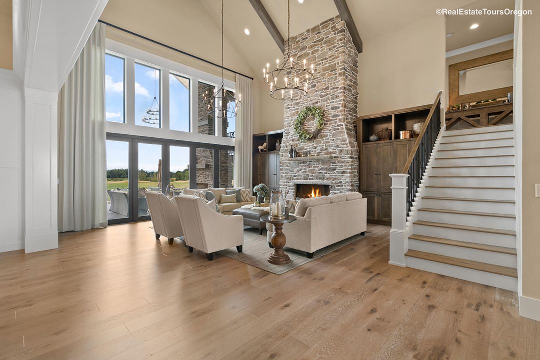 A living room with hardwood floors , a fireplace and stairs.