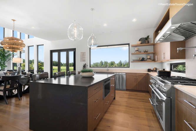 A kitchen with a large island and stainless steel appliances