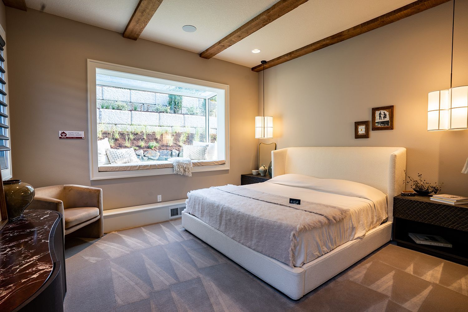 A bedroom with a large bed and a large window.