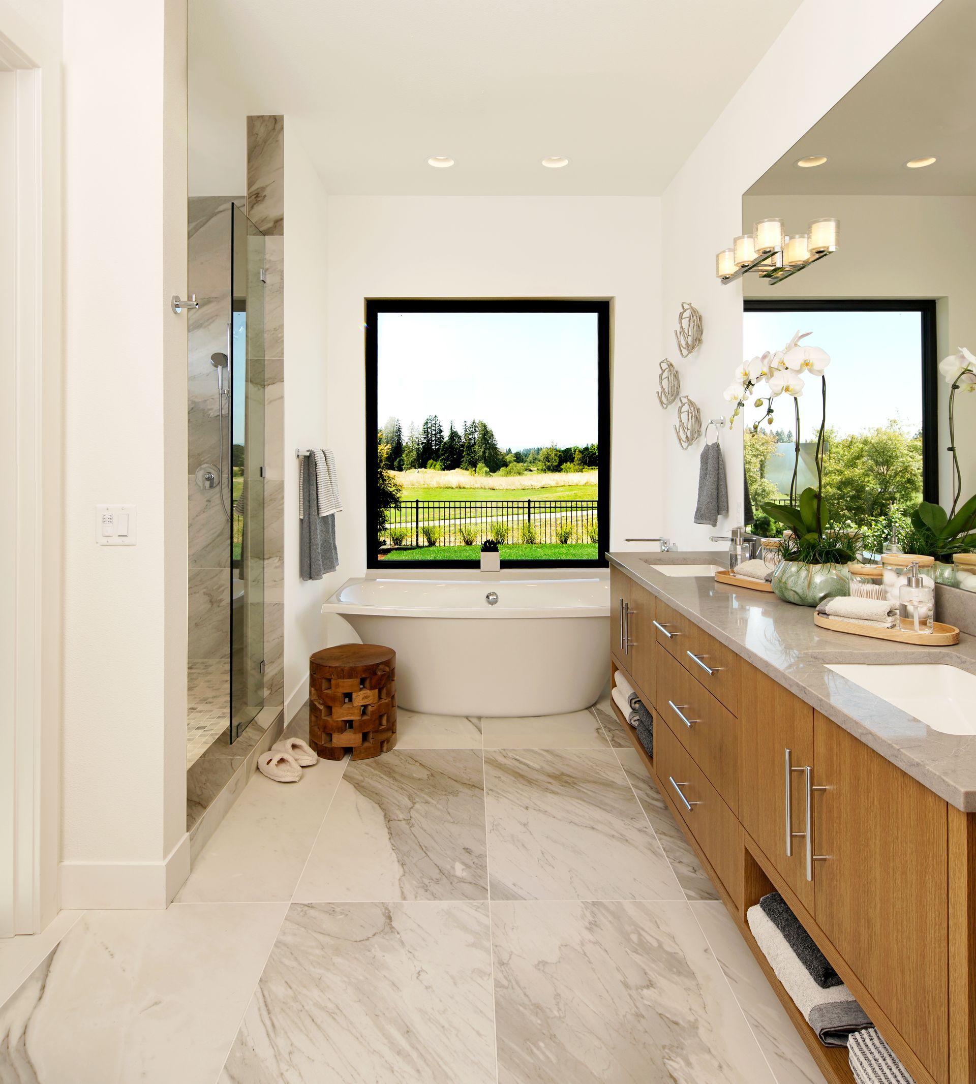 A bathroom with a large tub and a large window