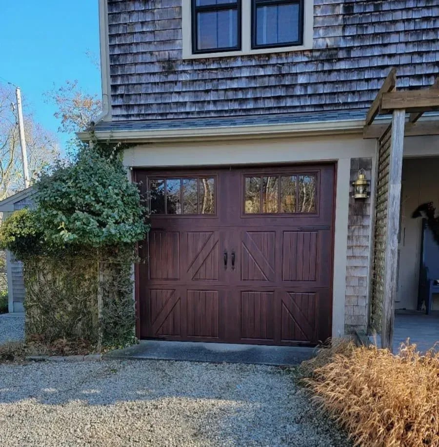 Brown garage door, two windows at the top