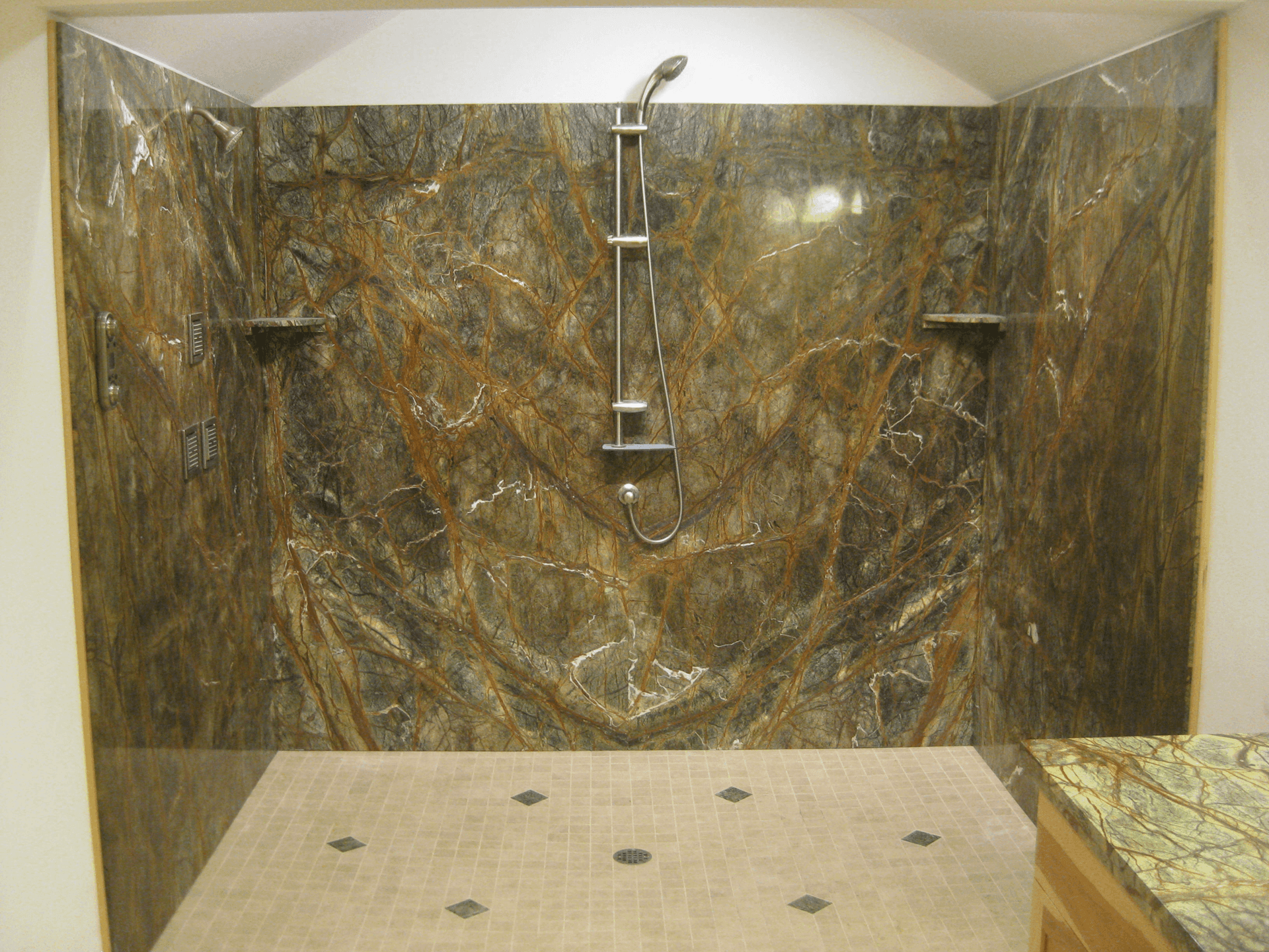 A bathroom with a shower and a marble wall