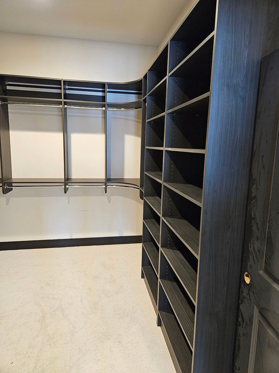 A spacious walk-in closet with lots of shelves
