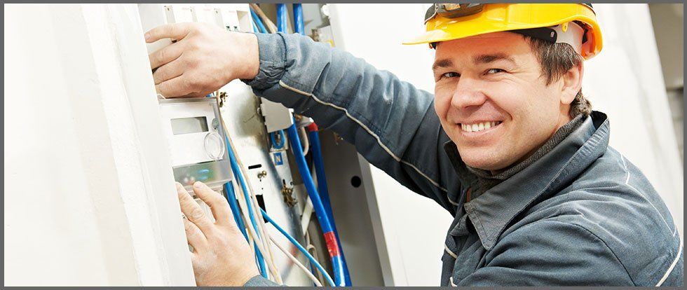 man working on electrical panel
