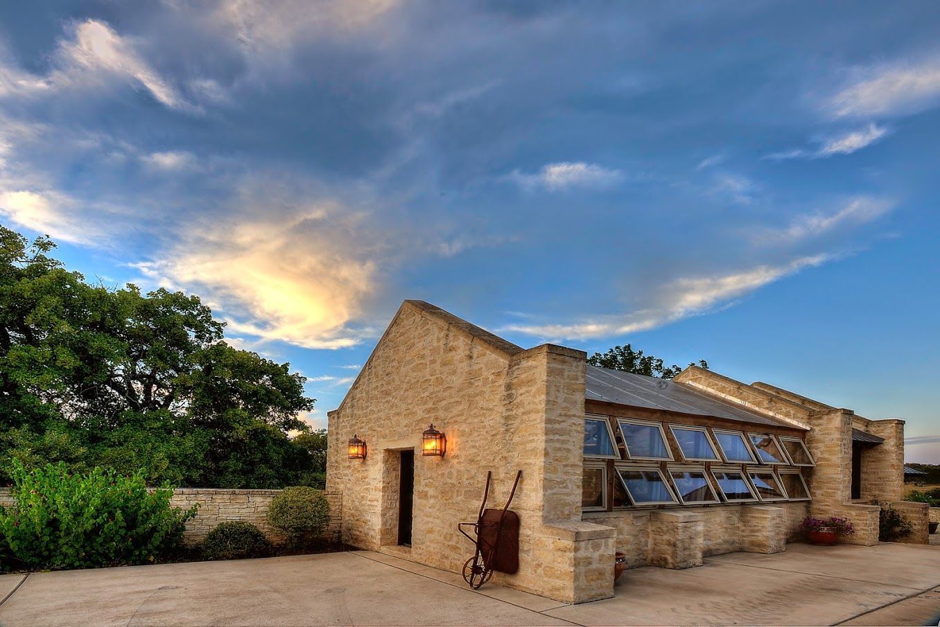 A stone building with a wheelbarrow in front of it