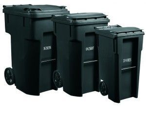 Three black trash cans are lined up in a row on a white background.