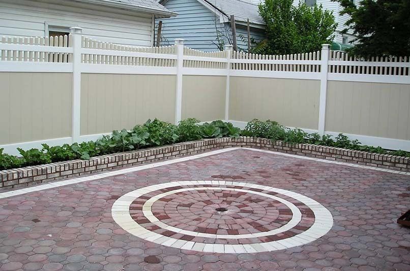 A brick patio with a white circle in the middle