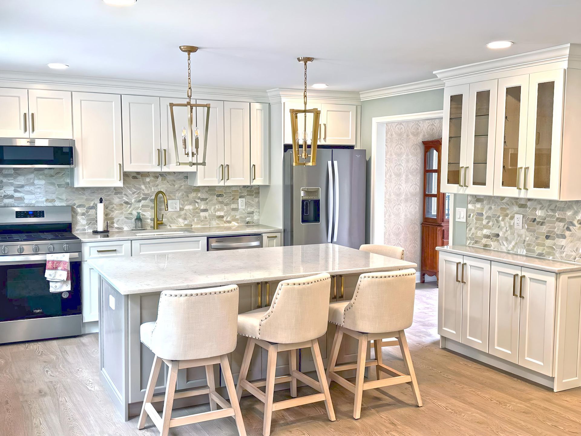 Modern kitchen with dark wood cabinets, island, and stainless steel appliances.