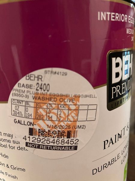 Close-up of a Behr paint can label. It shows the color 