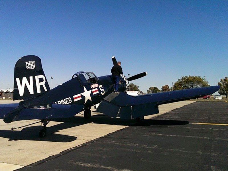 A plane with wr on the tail is parked on a runway