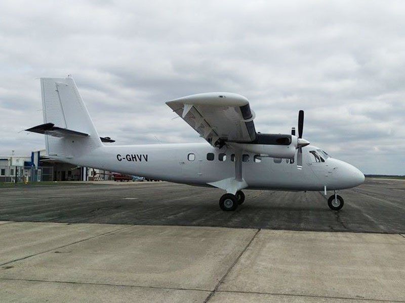 A small white plane with the letters g-smvn on the side