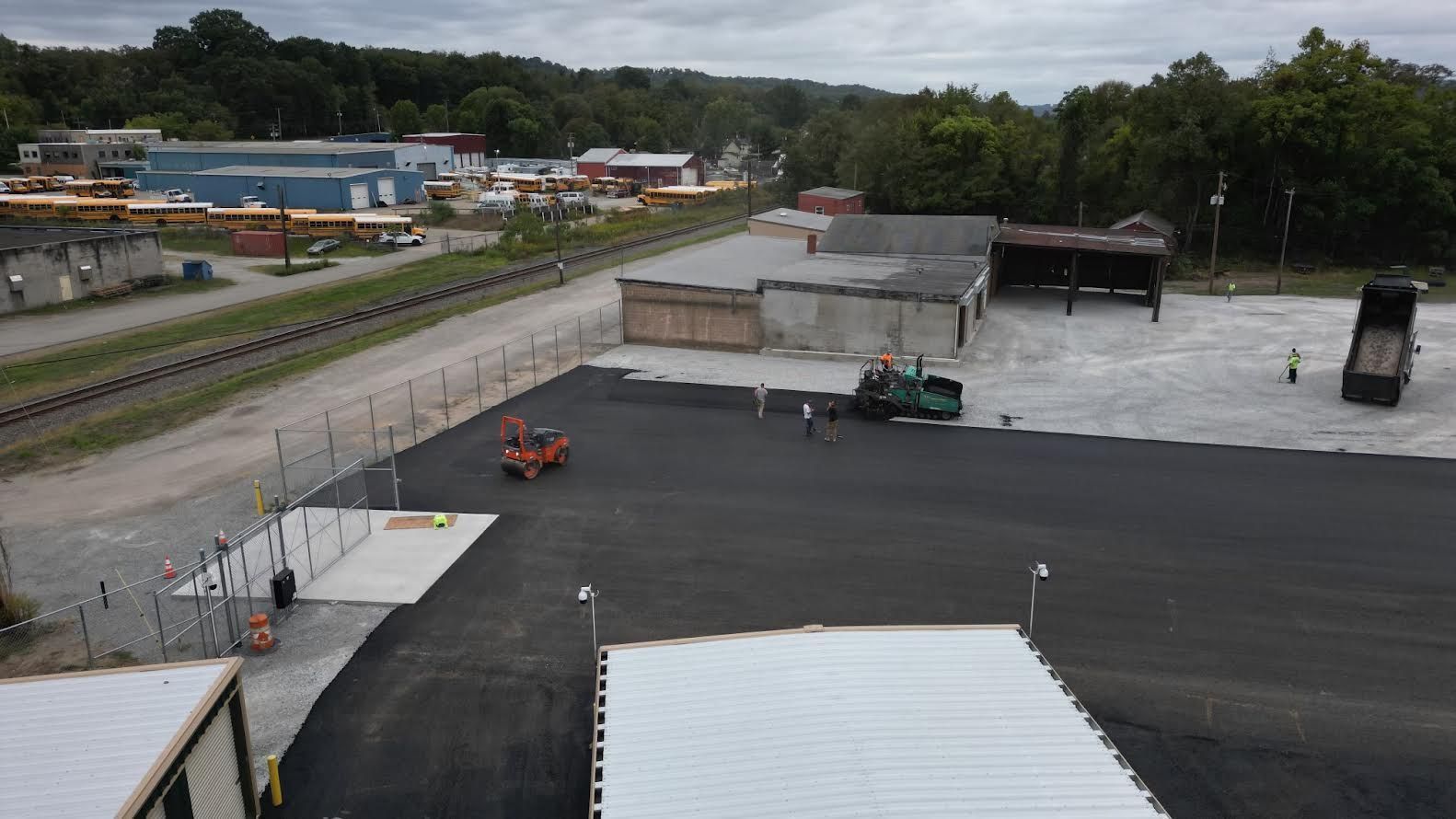 An aerial view of a large parking lot with a lot of buildings in the background.